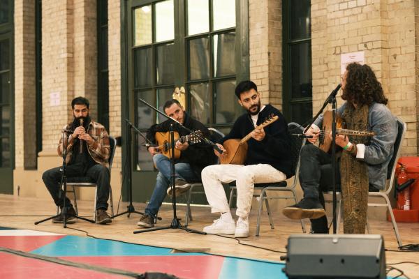 4 men performing acoustic music