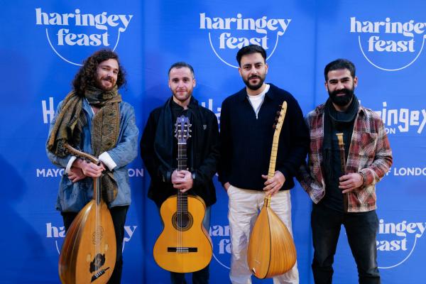 Image of four male musicians holding their instruments