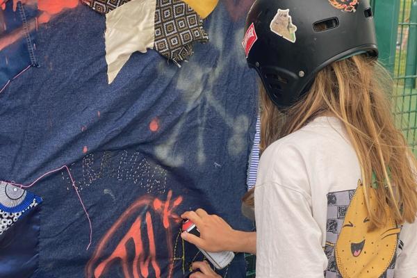 a quilt being tagged with spray paint